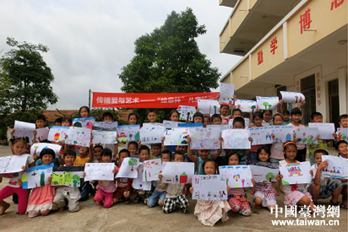 小朋友開心地展示自己的繪畫作品 小朋友開心地展示自己的繪畫作品