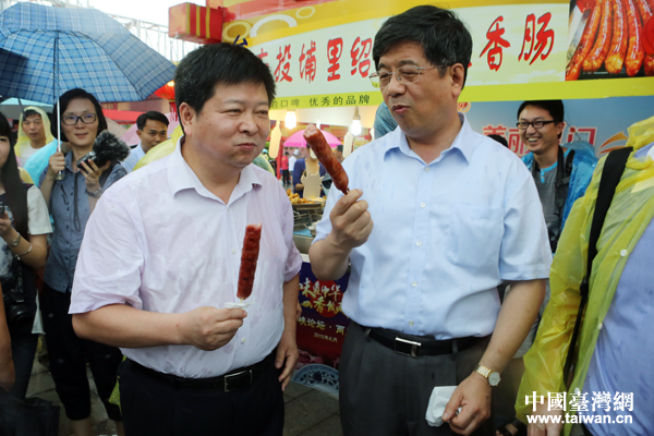 國臺辦副主任龍明彪自掏腰包，購買品嘗臺灣美味小吃。（中國臺灣網 何建峰 攝）